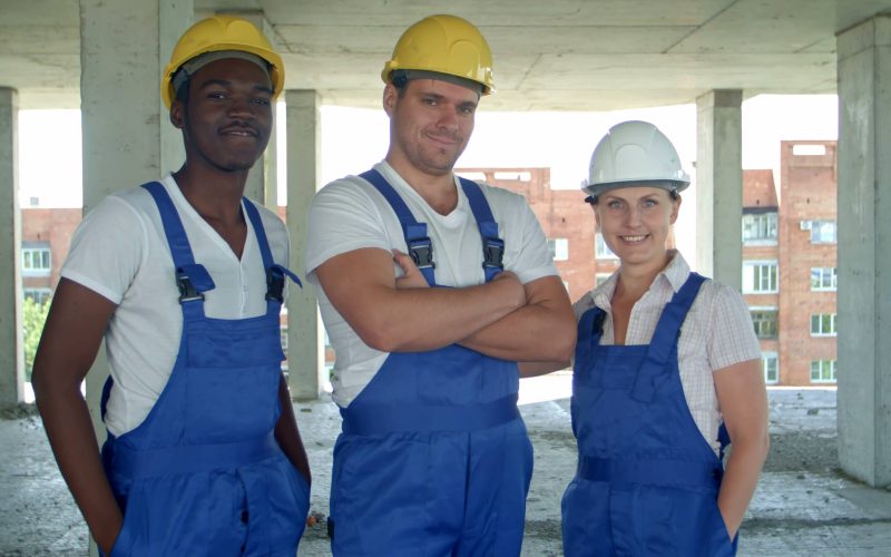 confident-diverse-team-of-workmen-and-women-standing-grouped-in-their-dungarees-and-ha-SBI-350449286_batcheditor_fotor